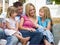 Family sitting on patio smiling