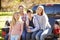 Family Sitting In Pick Up Truck On Camping Holiday