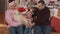 Family sitting on swing near the christmas tree at porch. Family concept