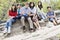 Family sitting together on rocky ledge