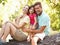 Family Sitting On Tree In Park