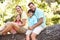 Family Sitting On Tree In Park