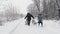 family sledding in winter. outdoor winter activity. Happy, laughing, playful family of 4 is enjoying of sledging their