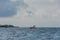 Family in a small red boat with a large norwegian flag..