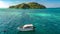 Family snorkeling near boat in clear tropical sea, aerial drone view from above, mother and kids snorkelers swimming in water