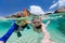 Family snorkeling in tropical water