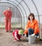 Family sows seeds at greenhouse