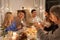 Family with sparklers having dinner party at home