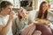 Family spending nice time together at home, looks happy and cheerful, eating pizza