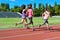 Family sport and fitness, happy mother and kids running on stadium track outdoors, children healthy lifestyle concept