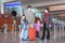 Family standing in airport hall with suitcases