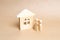 The family is standing near a wooden house. A couple of young people stand near their new home. Purchase and sale of housing.