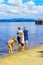 A family standing in water on summer at Loch Lomond, Luss, Scotland