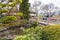 Family stands on bridge at Kasugai Japanese Gardens in downtown Kelowna