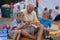 Family on Street Curb Watching Parade