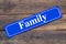 Family street sign on wooden background