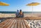 family in striped clothes sitting on the beach