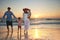 Family strolls on the beach at sundown. a young family enjoying a day at the beach.