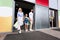 Family After Successful Shopping Holding Shopper Bags Leaving Mall