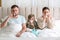 Family suffering from runny nose in bed at home