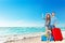 Family on Summer Holiday Vacations. Happy Smiling Parents with Kid sitting on Stack of Suitcases on Sea Side Sand Beach