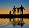 Family on sunset pond