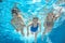 Family swim in pool or sea underwater, mother and children have fun in water