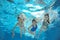 Family swim in pool or sea underwater, mother and children have fun in water