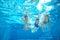 Family swim in pool or sea underwater, mother and children have fun in water