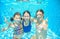 Family swim in pool or sea underwater, mother and children have fun in water