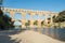 Family swimming in the GardÃ³n river, very close to the Roman aqueduct Pont du Gard.  France, Europe