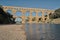 Family swimming in the GardÃ³n river, very close to the Roman aqueduct Pont du Gard.  France, Europe