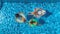 Family in swimming pool aerial drone view from above, happy mother and kids swim on inflatable ring donuts and have fun in water