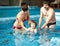 Family swimming in the pool. Happy family spends time and relax in the swimming pool