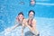 Family swims in pool underwater, happy active mother and child have fun under water, fitness and sport with kid on summer vacation