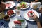 Family at the table eating strawberry desserts