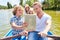 Family with tablet computer on a boat tour