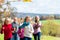 Family take walk in autumn forest flying kite