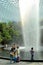 Family takes selfie photograph by waterfall and trees at Jewel Changi airport Singapore