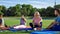 Family taking rest while training on stadium