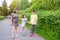 A family teaches a child to ride a skateboard in a park. Healthy lifestyle