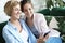 Family and technology. Aged woman and her adult daughter using smartphone at home.