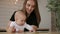 Family, technology and motherhood concept - happy smiling young mother with little baby and tablet pc computer at home