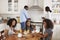 Family With Teenage Children Eating Breakfast In Kitchen