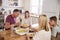 Family With Teenage Children Eating Meal In Kitchen