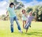 Family with teenager child playing with soccer ball