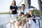 Family with teenagers relaxing together on boat