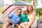 Family of three camping. Portrait of family of three sitting in front of tent and smiling.