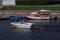 A family with three children makes a boat trip on a motor boat. Two girls sunbathe on the pier