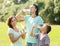 Family of three drinking from plastic bottles